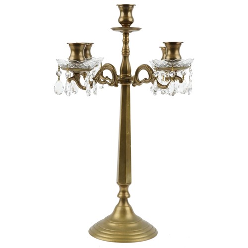 1713 - A late 20th century brass four branch candelabra with cut glass drip trays and drops, 58cm high.