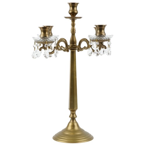 1713 - A late 20th century brass four branch candelabra with cut glass drip trays and drops, 58cm high.