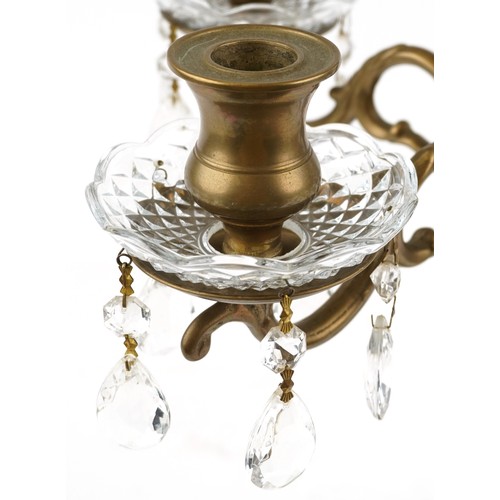 1713 - A late 20th century brass four branch candelabra with cut glass drip trays and drops, 58cm high.