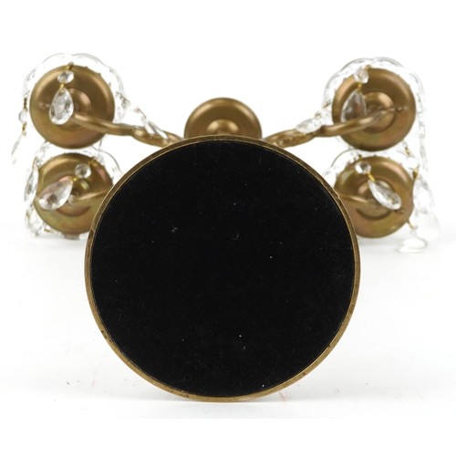 1713 - A late 20th century brass four branch candelabra with cut glass drip trays and drops, 58cm high.