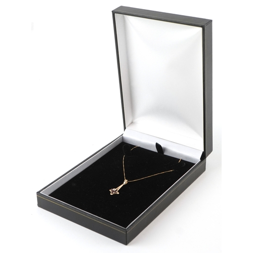 3304 - A 9ct gold garnet and diamond cluster pendant on a 9ct gold necklace, 2.6cm high and 48cm in length,... 