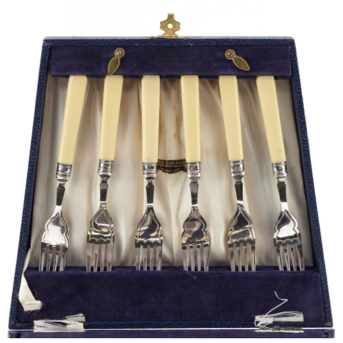 3748 - A set of six fish knives and forks with silver collars and silver plated blades housed in a fitted c... 