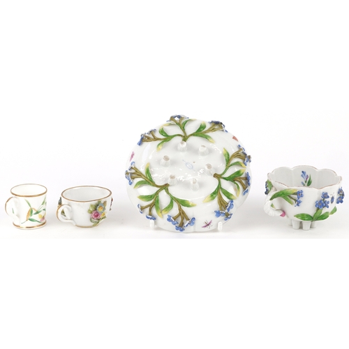 34 - A Meissen porcelain cup and saucer decorated with flowers together with a similar diminutive cup and... 