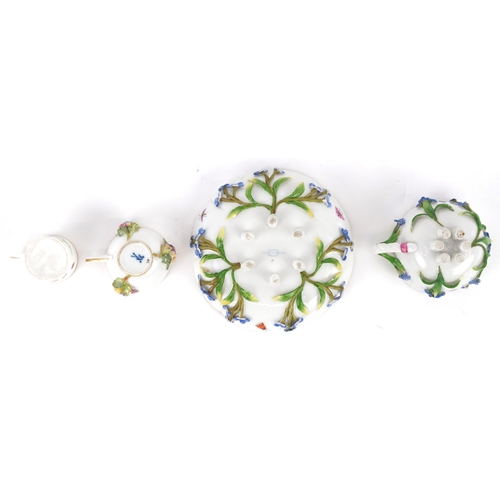 34 - A Meissen porcelain cup and saucer decorated with flowers together with a similar diminutive cup and... 