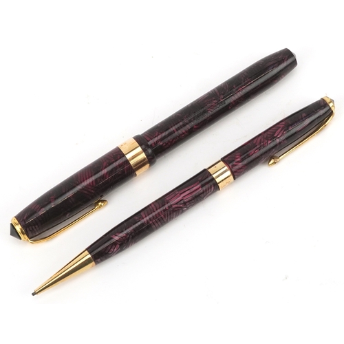 81 - A Conway Stewart fountain pen with 14ct gold nib and matching propelling pencil, cased, 18cm wide.