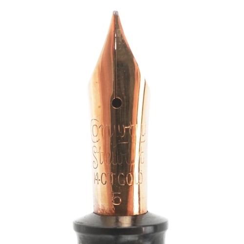 81 - A Conway Stewart fountain pen with 14ct gold nib and matching propelling pencil, cased, 18cm wide.