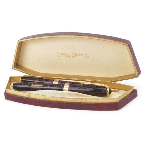 81 - A Conway Stewart fountain pen with 14ct gold nib and matching propelling pencil, cased, 18cm wide.