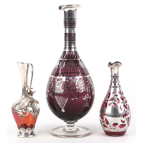 3738 - Three similar 20th century silver mounted cranberry glass vases with engraved decoration, the larges... 