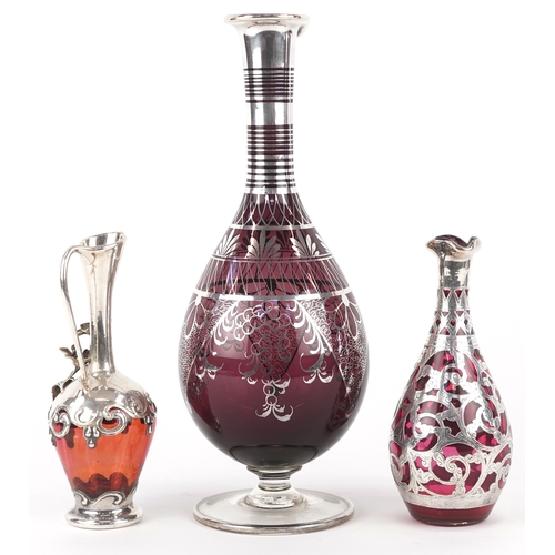 3738 - Three similar 20th century silver mounted cranberry glass vases with engraved decoration, the larges... 