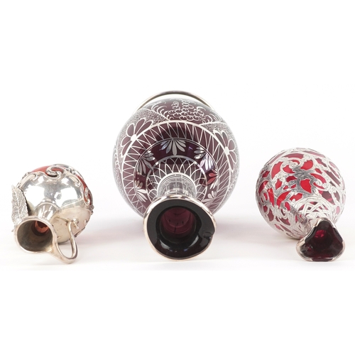 3738 - Three similar 20th century silver mounted cranberry glass vases with engraved decoration, the larges... 