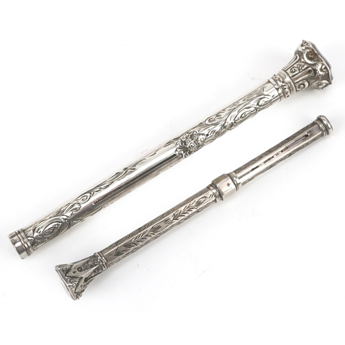 62 - Two unmarked silver cased engraved propelling pencils, one combined with a fountain pen, the largest... 