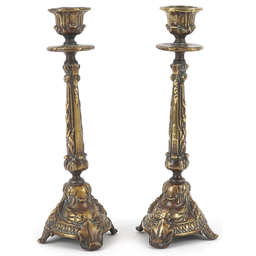 495 - A pair of gilt metal candlesticks with cast leaf decoration, 23cm high.