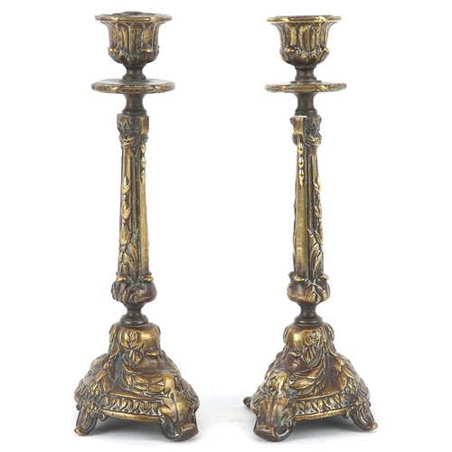495 - A pair of gilt metal candlesticks with cast leaf decoration, 23cm high.