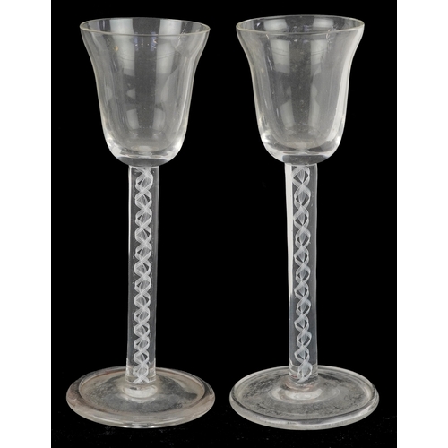 43 - A near pair of 18th century air twist stem glasses, each 14.5cm high.