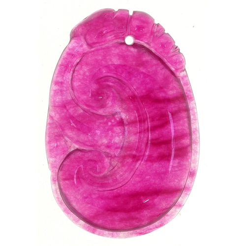 1499 - A Chinese carved pink stone pendant, tests as jade, 4cm high, 12.4g.