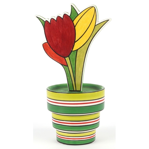 622 - Clarice Cliff by Wedgwood, a hand painted pottery study of flowers in a vase, 18cm high.