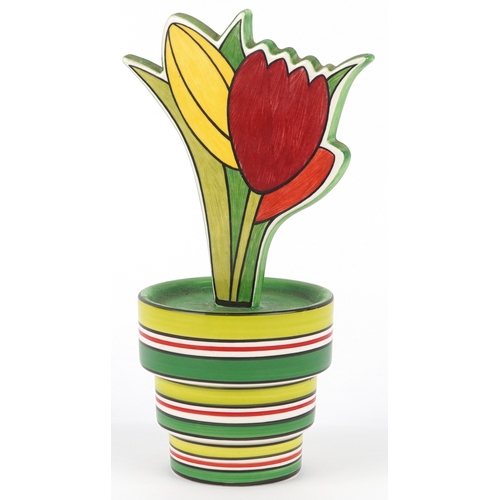 622 - Clarice Cliff by Wedgwood, a hand painted pottery study of flowers in a vase, 18cm high.