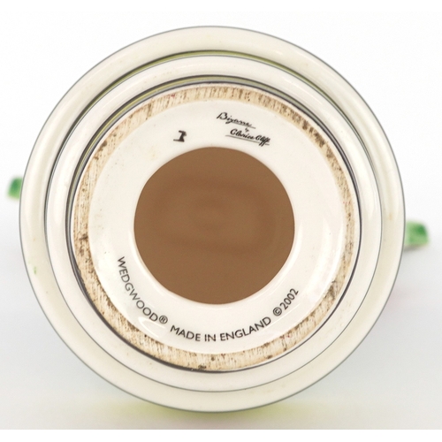 622 - Clarice Cliff by Wedgwood, a hand painted pottery study of flowers in a vase, 18cm high.