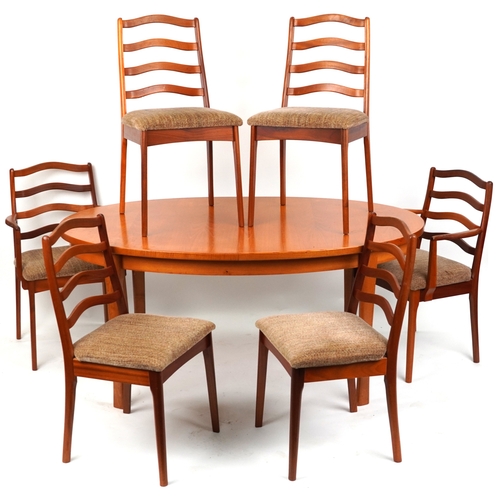 2097 - A mid 20th century teak oval extending dining table, 74cm H x 162cm W x 100cm D together with a matc... 