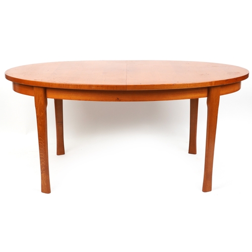 2097 - A mid 20th century teak oval extending dining table, 74cm H x 162cm W x 100cm D together with a matc... 