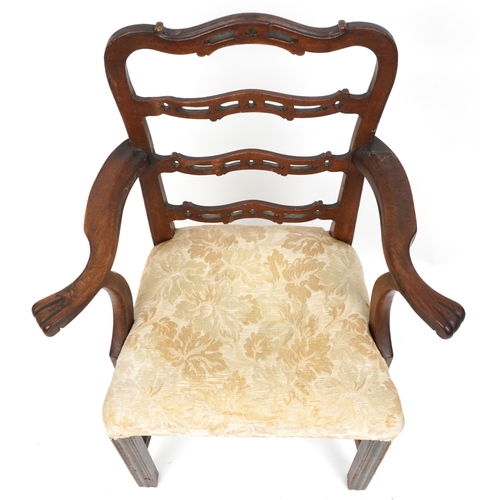 2160 - A 19th century mahogany pierced ladder back elbow chair, the overstuffed seat raised on moulded bloc... 