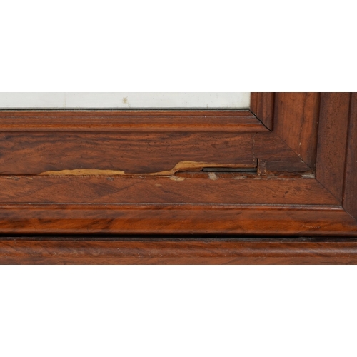 2002 - A 19th century walnut armoire, the arched pediment above a mirrored panel door, the base fitted with... 