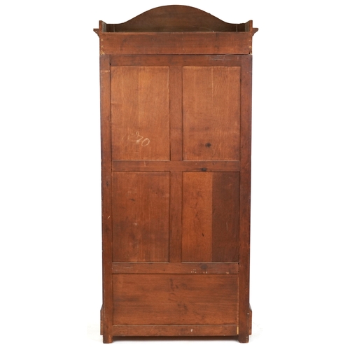 2002 - A 19th century walnut armoire, the arched pediment above a mirrored panel door, the base fitted with... 