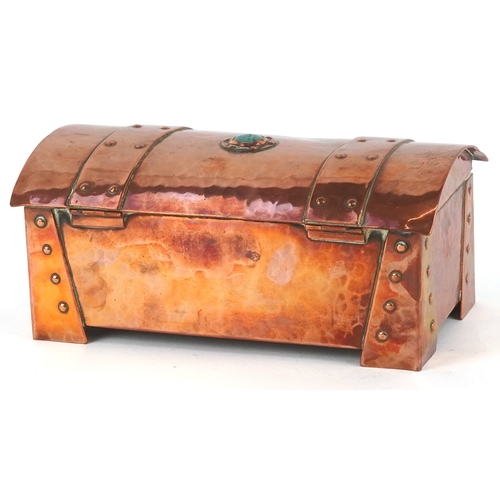 11 - An Arts & Crafts copper domed top cigarette box, the top and front with inset Ruskin type cabochon r... 