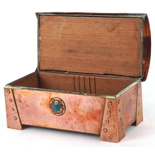 11 - An Arts & Crafts copper domed top cigarette box, the top and front with inset Ruskin type cabochon r... 