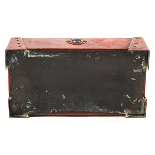 11 - An Arts & Crafts copper domed top cigarette box, the top and front with inset Ruskin type cabochon r... 