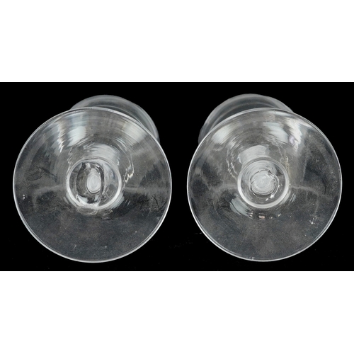 44 - A near pair of 18th century air twist stem glasses, each 13.5cm high.