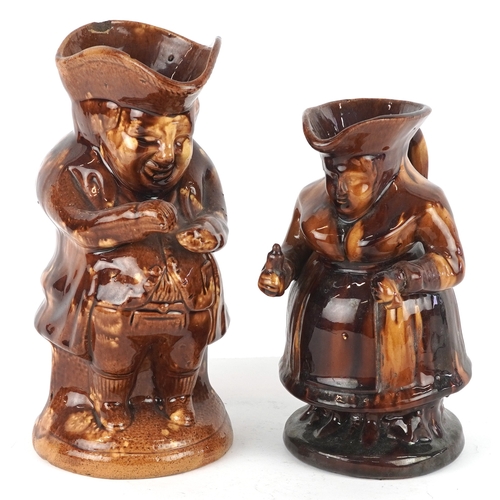 518 - Two Victorian treacle glazed Toby jugs, the largest 24cm high.