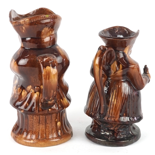 518 - Two Victorian treacle glazed Toby jugs, the largest 24cm high.