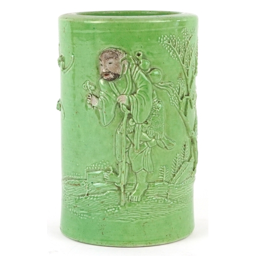 458 - A Chinese porcelain green ground brush pot decorated in relief with an elder and fruit bats, 15cm hi... 