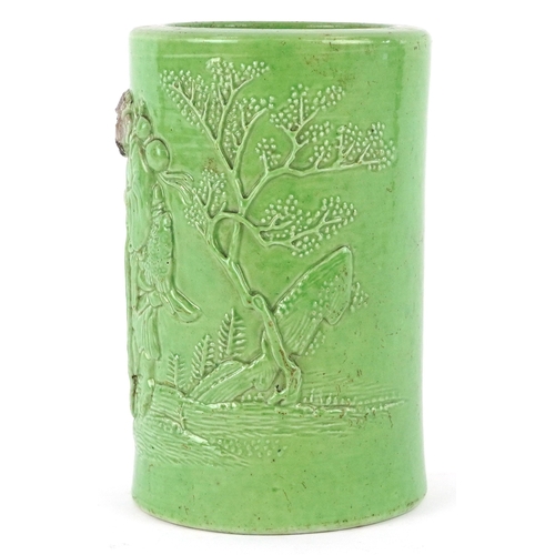 458 - A Chinese porcelain green ground brush pot decorated in relief with an elder and fruit bats, 15cm hi... 