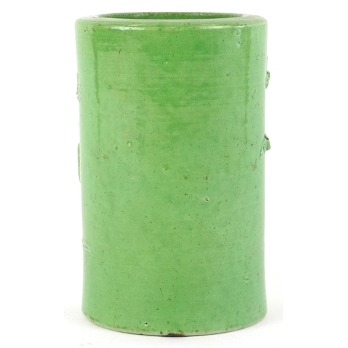 458 - A Chinese porcelain green ground brush pot decorated in relief with an elder and fruit bats, 15cm hi... 