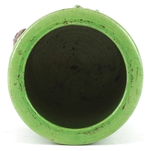 458 - A Chinese porcelain green ground brush pot decorated in relief with an elder and fruit bats, 15cm hi... 