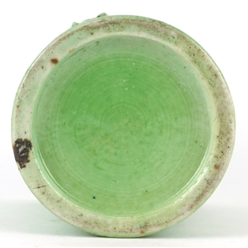 458 - A Chinese porcelain green ground brush pot decorated in relief with an elder and fruit bats, 15cm hi... 