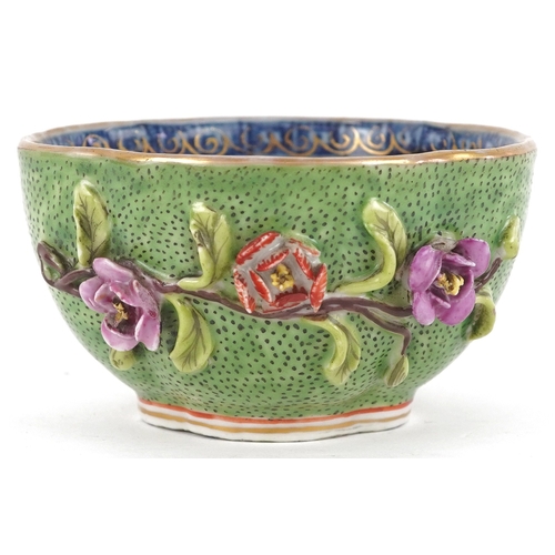 90 - A Chinese porcelain four lobed tea bowl moulded in relief with flower sprays, 19th century, 4.5cm hi... 
