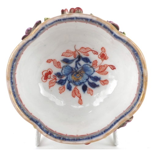 90 - A Chinese porcelain four lobed tea bowl moulded in relief with flower sprays, 19th century, 4.5cm hi... 