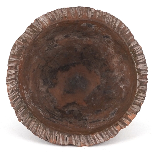 1501 - A Minoan style pottery bull and axehead cup, 6cm high.