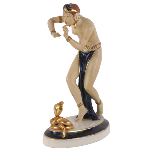 487 - A Royal Dux Czechoslovakian porcelain figure of a snake charmer, 24cm high.