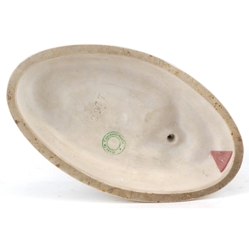 487 - A Royal Dux Czechoslovakian porcelain figure of a snake charmer, 24cm high.