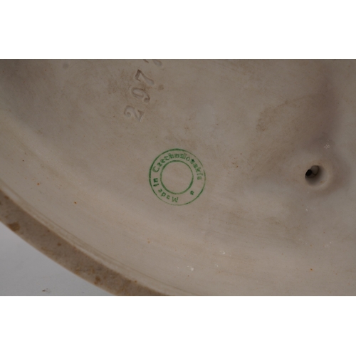 487 - A Royal Dux Czechoslovakian porcelain figure of a snake charmer, 24cm high.