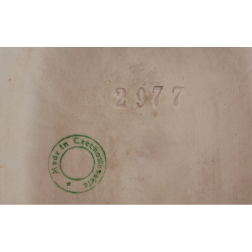 487 - A Royal Dux Czechoslovakian porcelain figure of a snake charmer, 24cm high.