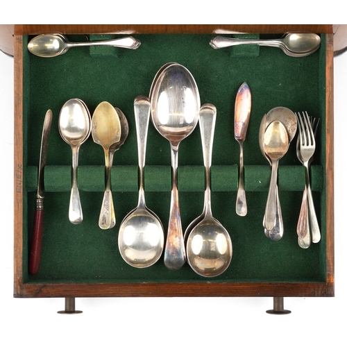 3749 - An Art Deco walnut cased canteen of stainless steel cutlery, 36cm wide.