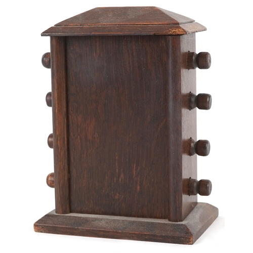 130 - An early 20th century oak desk calendar, 17cm high.