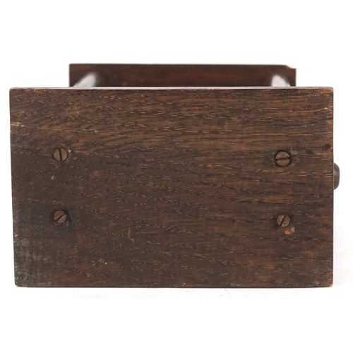 130 - An early 20th century oak desk calendar, 17cm high.
