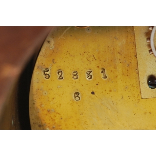 128 - An Edwardian mahogany cased mantle clock with chequer stringing, the white enamelled dial inscribed ... 