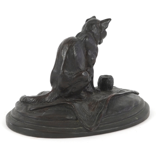 1451 - After E. Fremiet, a bronzed sculpture of a cat on a rug on an oval plinth base, 9cm high.